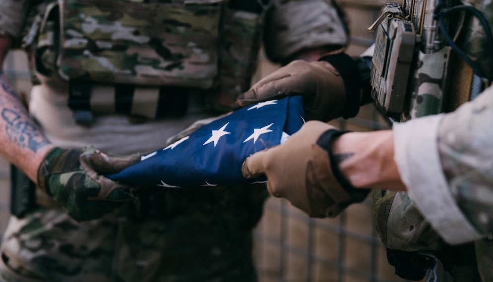 Operators holding a folded flag.